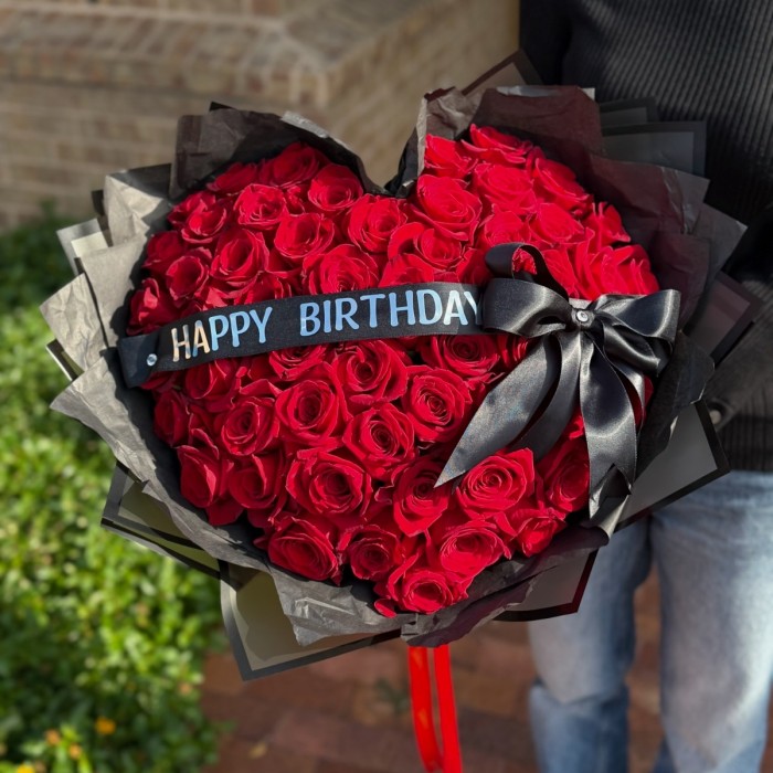 Heart-shaped bouquet of 50 red roses in black wrapping